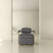 Modern gray armchair with gold frame in minimalist neutral interior setting